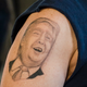 Anthony Borbell, 44, of Warren, Ohio shows his tattoo of Republican Presidential Candidate Donald Trump at Youngstown Airport on March 14, 2016 (Getty Images)